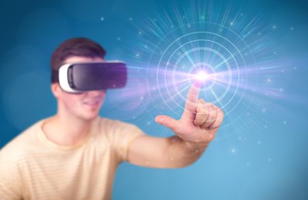 young-impressed-man-wearing-virtual-reality-588164537 Young impressed man wearing virtual reality goggles with blue circles around his finger