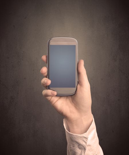 caucasian-hand-business-suit-holding-blank-588164684 Caucasian hand in business suit holding a blank screen smartphone