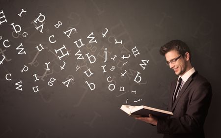 Casual young man holding book with white alphabet flying out of it