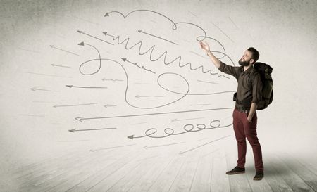 Handsome young man standing with a backpack on his back and scribbles in the background