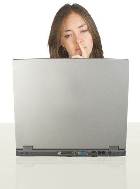 business woman browsing the web on a laptop at her desk