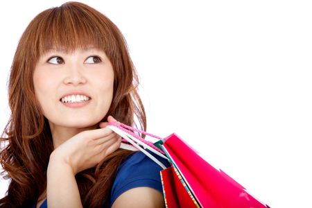 Asian shopping woman with bags - isolated over a white background