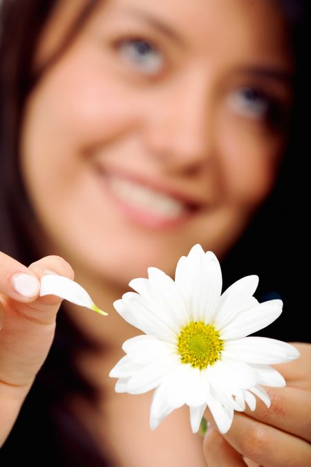 girl with a white flower taking petals off - loves me or not