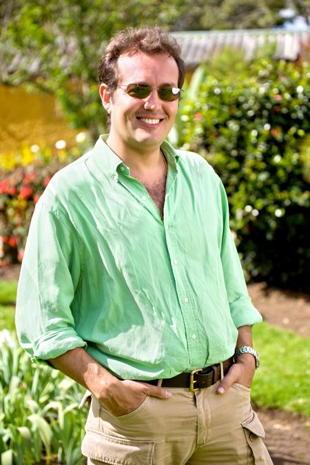 casual male portrait outdoors smiling and wearing sunglasses
