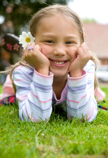 beautiful child portrait with a flower on her ear