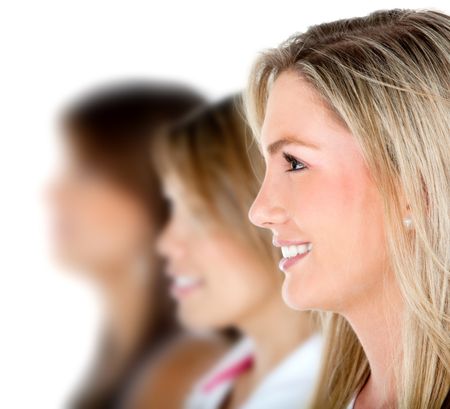 Group of females in a row smiling - isolated over a white background