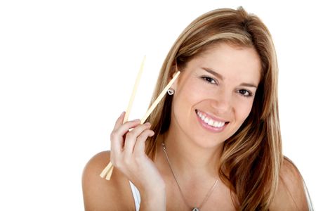 Woman holding chopsticks and smiling - isolated over a white background