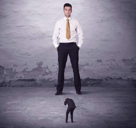 Angry big manager looking at small business man concept on background