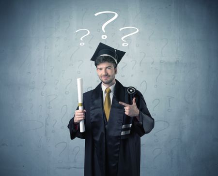 Young graduate teenager with question marks drawn over his head