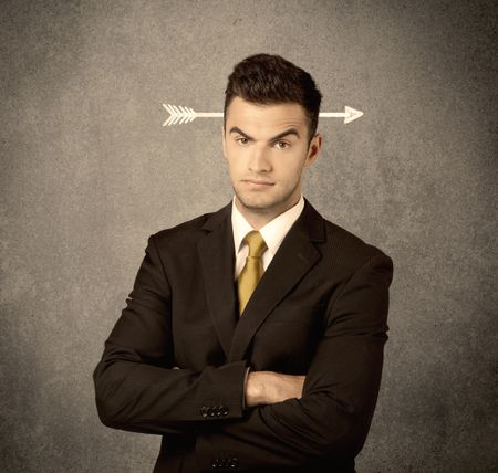 A confused young business guy giving thumbs up with a drawn arrow going through his head concept