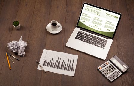 Business wooden table with notebook computer and office accessories