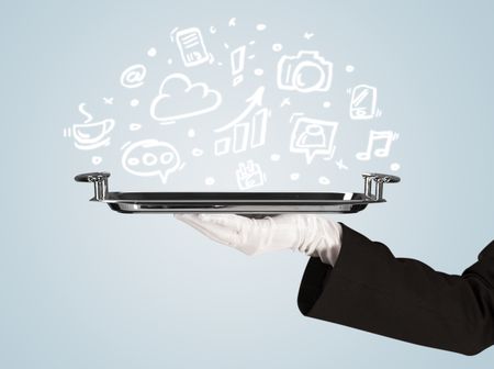 A professional waiter holding a silver plate with drawn communication, business and online media icons in front of a light blue background