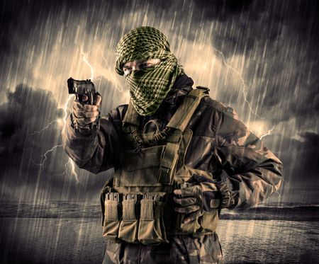 Portrait of a dangerous armed terrorist with mask and gun in a thunderstorm with lightning