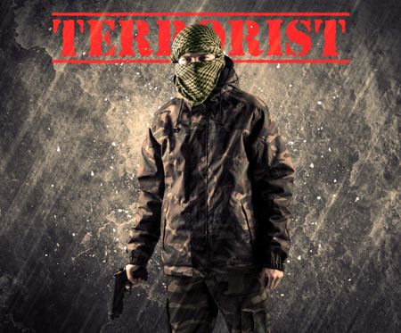 Portrait of dangerous masked and armed man with terrorist sign on grungy background