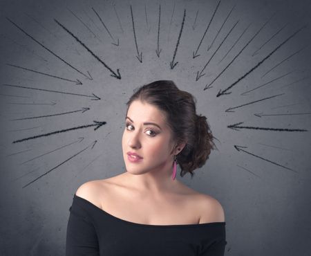 teenage-student-girl-pressure-making-happy-593375630 A teenage student girl under pressure while making happy face expressions illustrated with black arrows pointing at her head on the wall blackground concept.