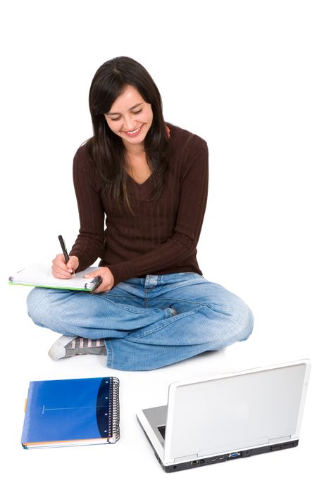 college student on the floor with notebooks and a laptop isolated over a white background