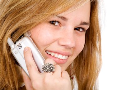 beautiful teenage blonde on a mobile phone smiling isolated over a white background