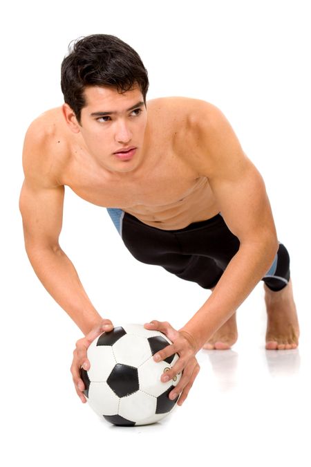 fashion male body leaning on a football ball isolated over a white background