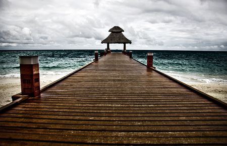 Beautiful pier on a cloudy, wavy day