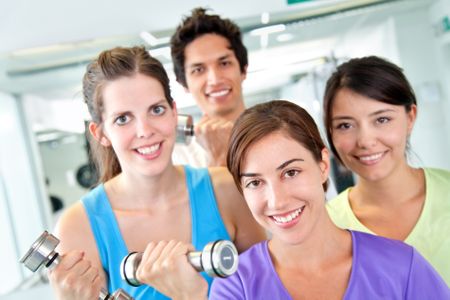 Group of fit people at the gym with free-weights