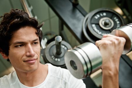 Strong man lifting free weights at the gym