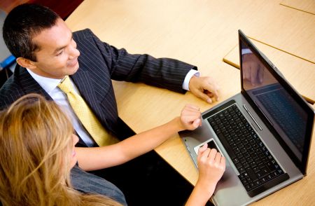 Business couple working on a laptop computer at the office