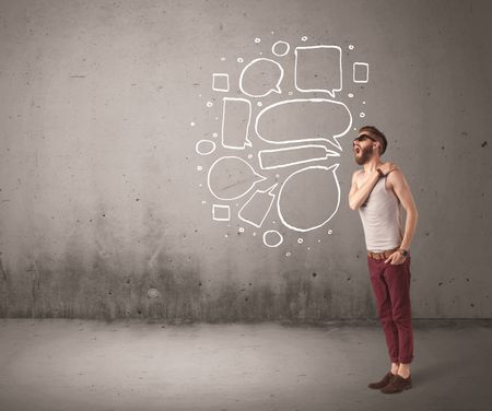 comic-hipster-guy-shouting-front-grey-598898459 A comic hipster guy shouting in front of grey urban concrete wall with drawn empty text bubbles around his mouth concept