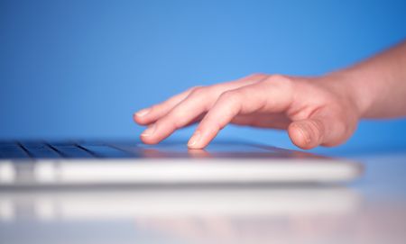 Close up of hand pressing keyboard buttons on desk