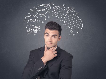 Young businessman with drawn speech bubbles over his head