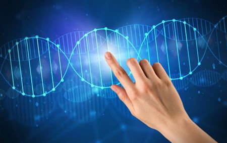 Female hand touching DNA molecule with blue background 