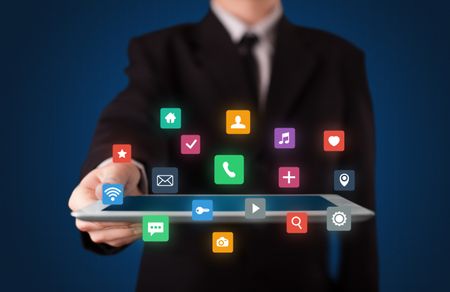 Businessman holding tablet with colorful applications