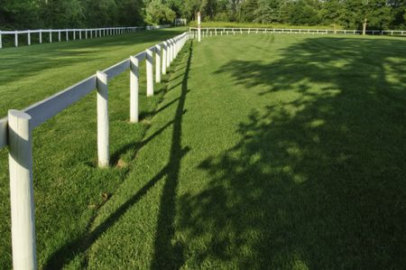 Dramatic perspective of training racetrack for horses on late summer afternoon