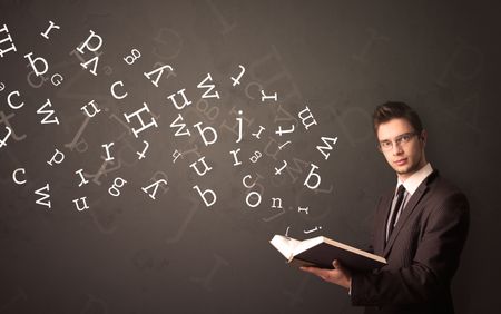 Casual young man holding book with white alphabet flying out of it