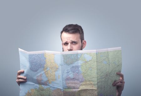 Handsome young man holding map