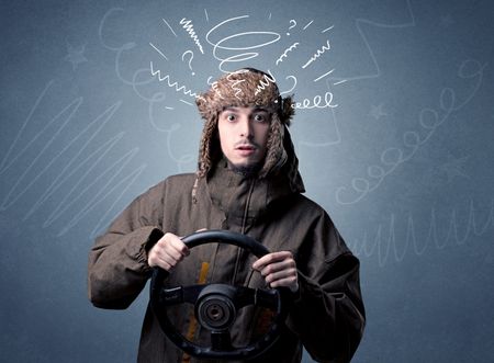 Young man holding black steering wheel with white scribbles around him