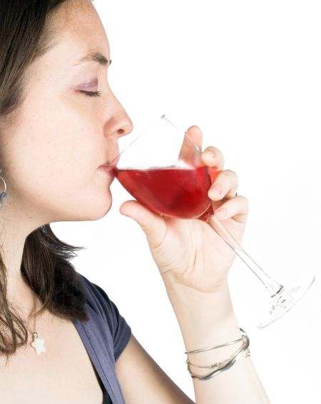 beautiful girl enjoying a glass of rose wine with her eyes closed
