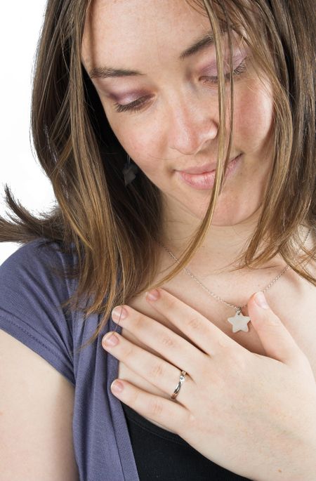 casual woman looking down wearing an engagement ring