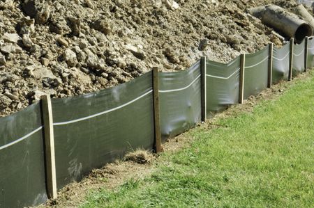Temporary retaining wall of green plastic on construction site