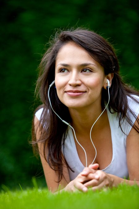 Girl with earphones listening to music outdoors