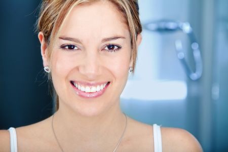 Beauty portrait of a female smiling in a bathroom