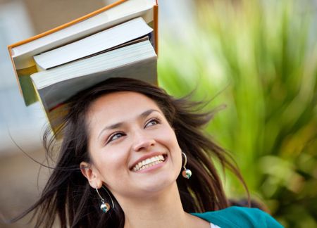 Woman carrying books on her head and trying to balance them