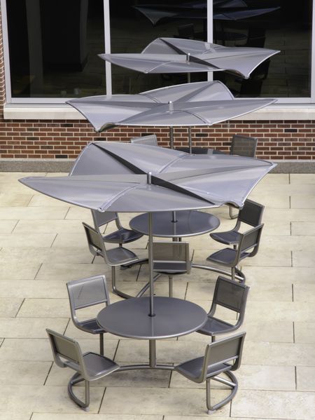 Cafe tables and chairs on courtyard of college campus