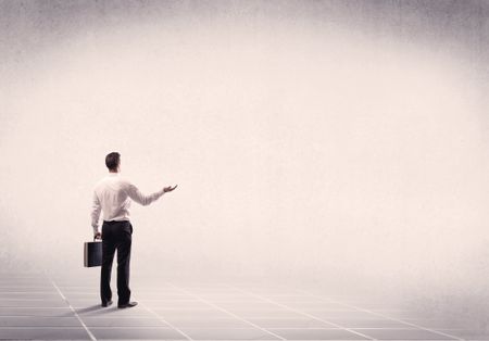 Office worker with briefcase standing with his back facing an empty space with filtered color concept