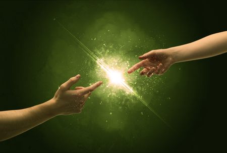 two-naked-male-hands-touch-lighting-603592364 Two naked male hands about to touch, lighting the spark with modest explosion in front of green background concept