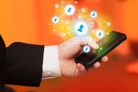 Finger pointing on smartphone with social network illustration