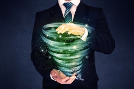 Bright green tornado in the hands of a businessman 
