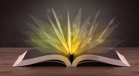 Yellow lights spreading from an open book 