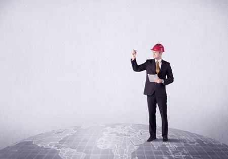 An elegant young male businessman standing on top of the world, pointing up concept with drawn earth map.
