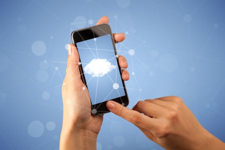 Female fingers touching smartphone with cloud concept