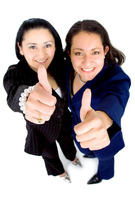 successful business partnership - two businesswomen doing the thumbs up sign isolated over a white background